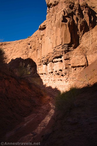 Hiking down the lower portion of the slot in Caramel Canyon, Goblin Valley State Park, Utah