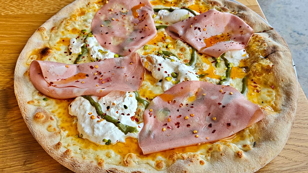 Pizza Bianca mit Mortadella, Bufalina, Pistazienpesto, scharfes Öl und Chilli