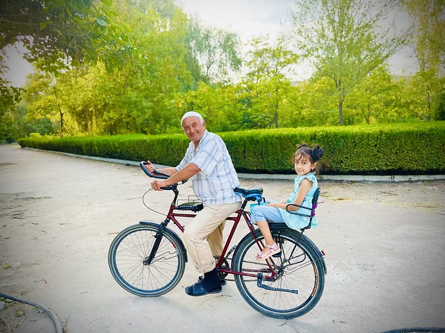 Older man and a girl on a bike