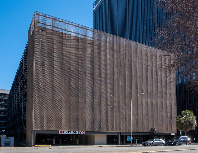From 1974, a disguise for a parking garage in the U.S. subtropics: A brown metal screen façade.