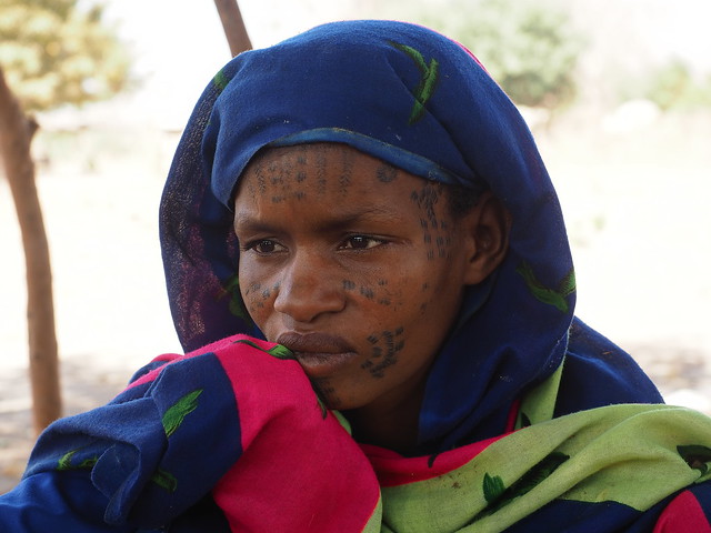 Once proud nomads, these Wodaabe families were forced to relocate after the loss of their cattle. Her face reflects sadness and nostalgia