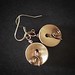 Swirl gold 2 hole button earrings.