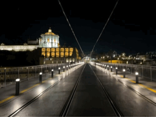Night view of Dom Luís I Bridge with tram tracks in Vila Nova de Gaia, Porto, Portugal, February 2023
