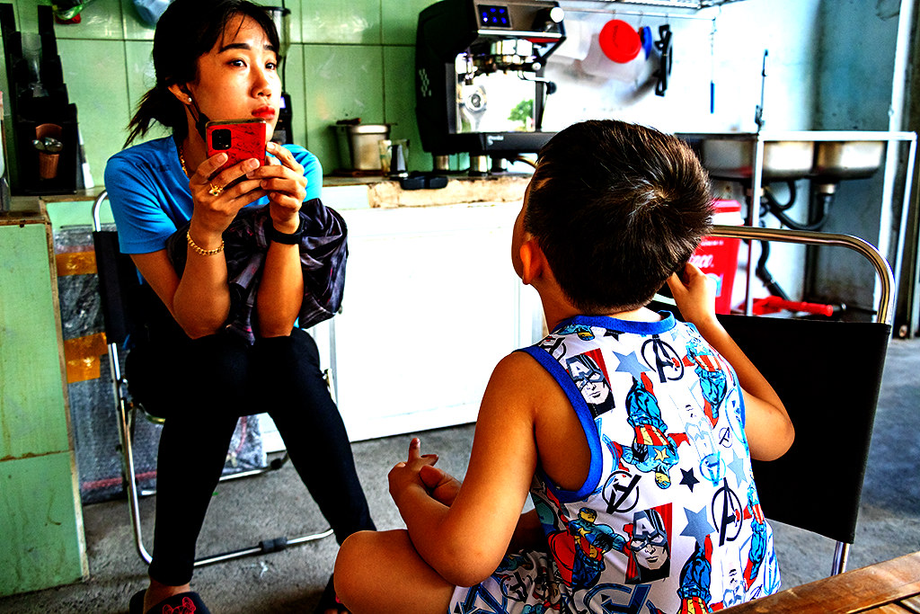 Woman with son in Captain America shirt at Bitter Coffee on 2-24-24--Vung Tau copy