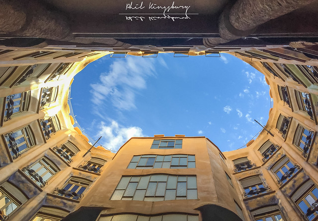 Looking towards the sky from the larger of the two courtyards in Casa Mila (La Pedrera), regarded as Antoni Gaudi’s most iconic work of civic architecture, Barcelona, Catalonia, Spain