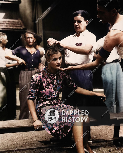 29th August 1944: This girl pays the penalty for having had personal relations with the Germans. Here, in the Montelimar area, France, French civilians shave her head as punishment.