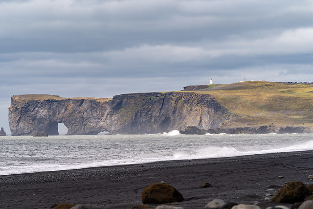 Black sand beach looking toward sea stacks and arches, in Vik, Iceland, Dyrholaey