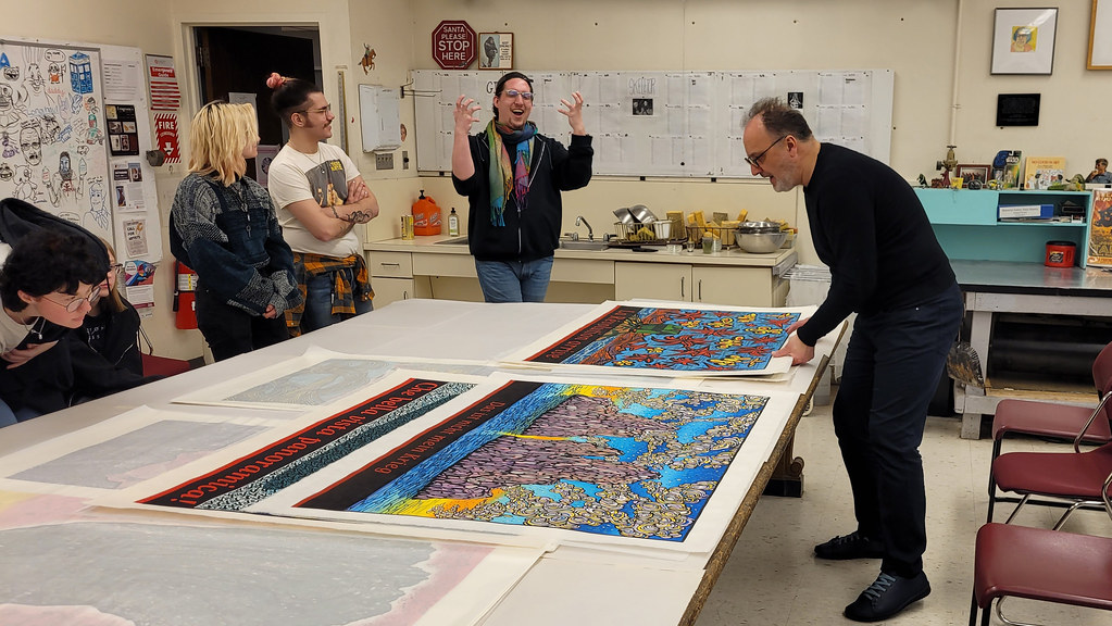 Endi Poskovic showing his prints to Sarah's Relief Print Class