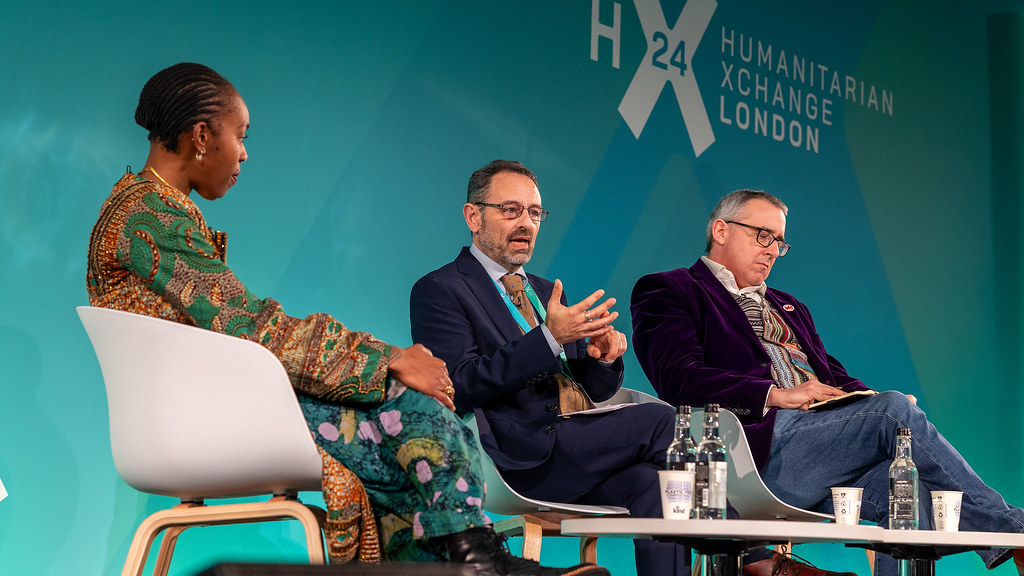 Professor Jason Hart on stage during the Humanitarian Xchange 2024 event in London.