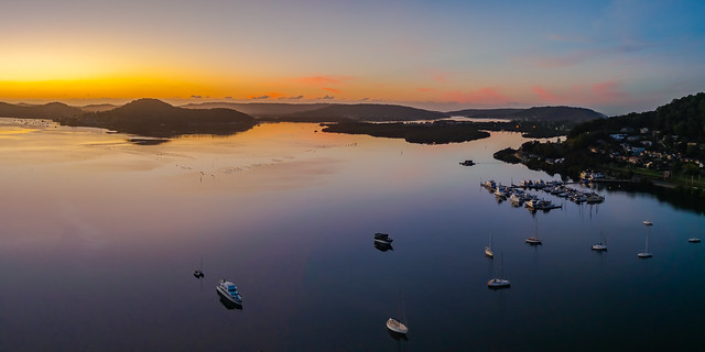 Aerial drone sunrise waterscape over the bay and boats