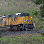 UP 9101 - Altamont Pass IOANP-3 with UP 9101 an SD70AH is starting the descent down Altamont Pass as the train exists the Altamont siding at the summit. The train is about to pass over Altamont Pass Road on the bridge. 