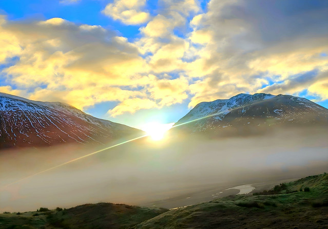 Sunrise peaking through mountain valley, Scotland, landscape