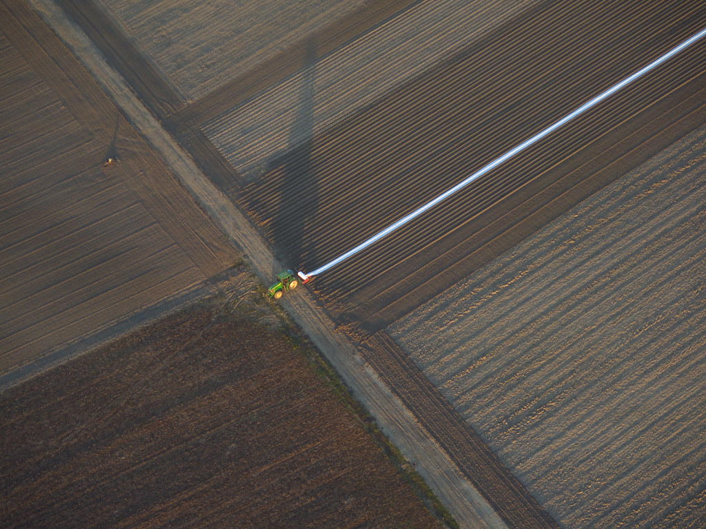Tractor Spreading Foil Over a Field