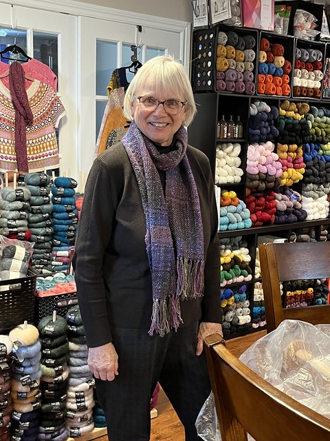 Carol came in for yesterday’s k it afternoon, to bring back the loom she used for our recent weaving class and to show off her finished Orchid Blossom Woven Scarf.