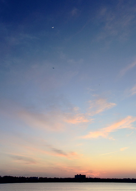 Sunset with the crescent moon and two airplanes