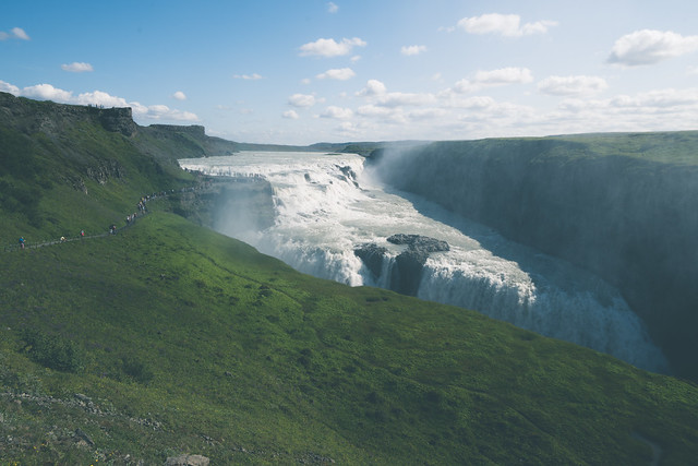 Gullfoss Waterfall - with paths leading to various overlooks, in Iceland during summer. Busy crowds of tourists