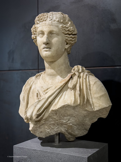 Part of a female statue, probably depicting a Muse