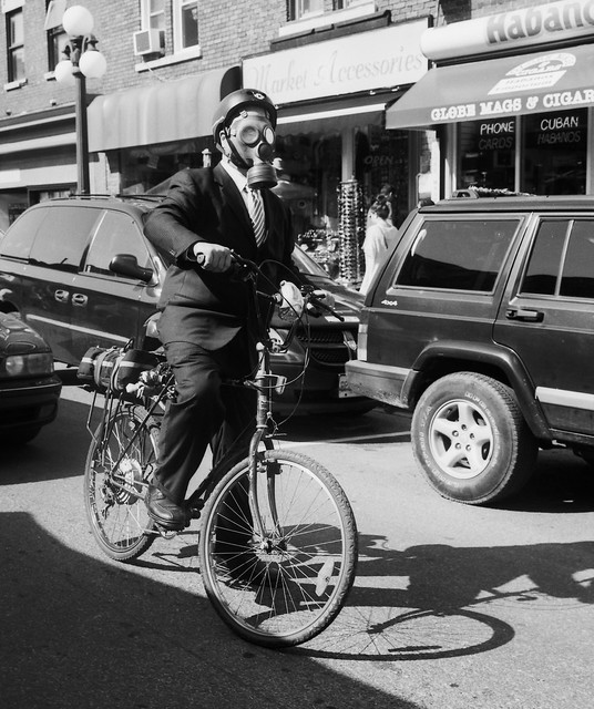 Man on a Bicycle with a Gas Mask