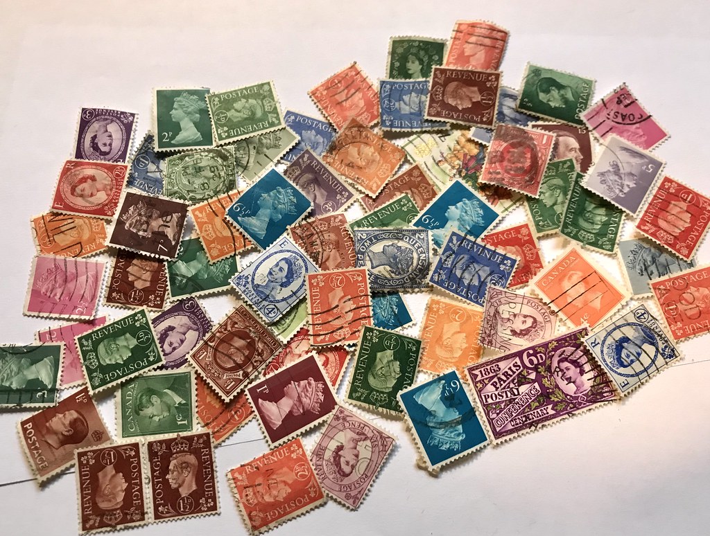 Todays challenge: can you find the German dictator stamp among all Windsors? Philatelist collection of vintage stamps. Bonus quest: can you find Victoria? Collectors and hobby of postal revenue