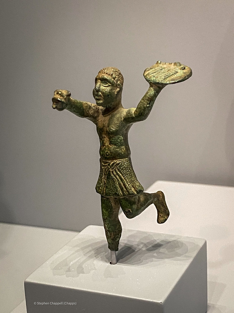 Bronze statuette of a boy (slave?) running with a tray of food