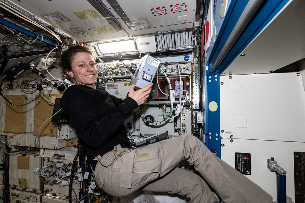 NASA astronaut Loral O'Hara shows off the Advanced Space Experiment Processor-2