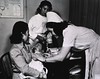 Nurse Administering An Immunization Shot to a Baby