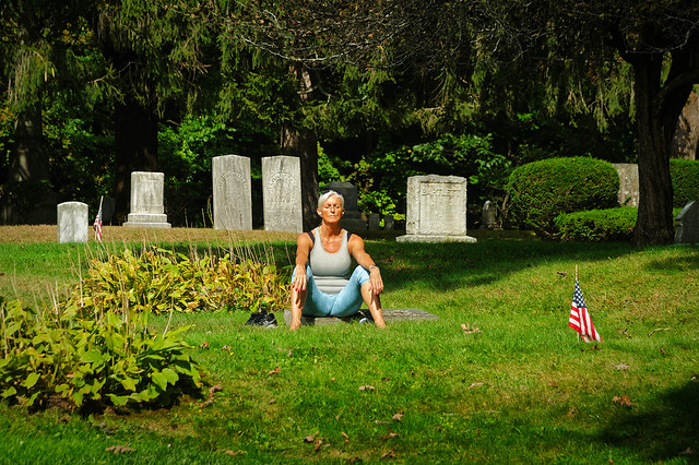 Women relaxes in a graveyard under the warm autumn sun