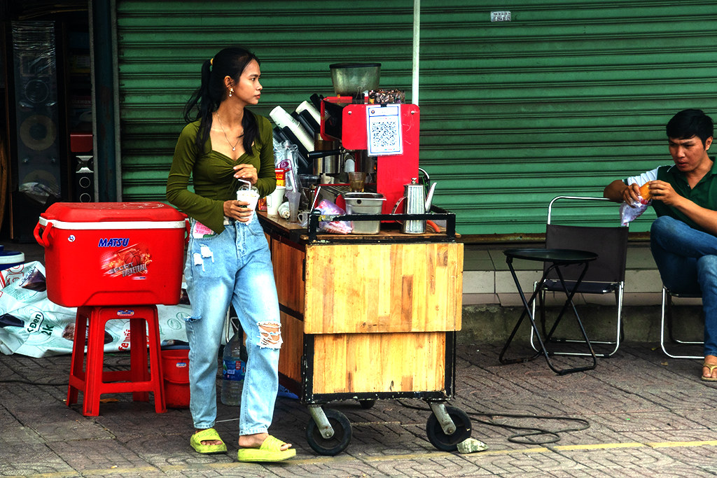 Young woman at sidewalk coffee stand on 3-29-24--Saigon copy