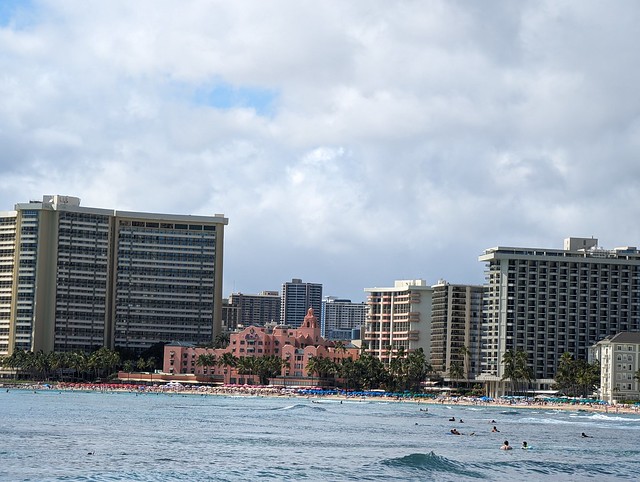 Bustling Waikiki Beachfront Scene With Towering Hotels and Turquoise Waters on a Cloudy Day