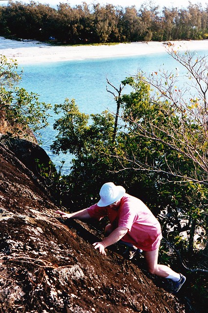 Mary scrambles up boulder on Russell Is Qld