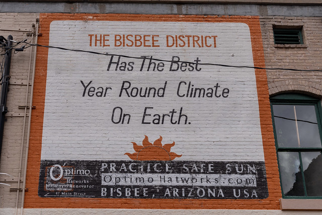 Bisbee, Arizona - December 20, 2023: Mural on the side of a brick building advertising Bisbee as having the best year round climate on earth