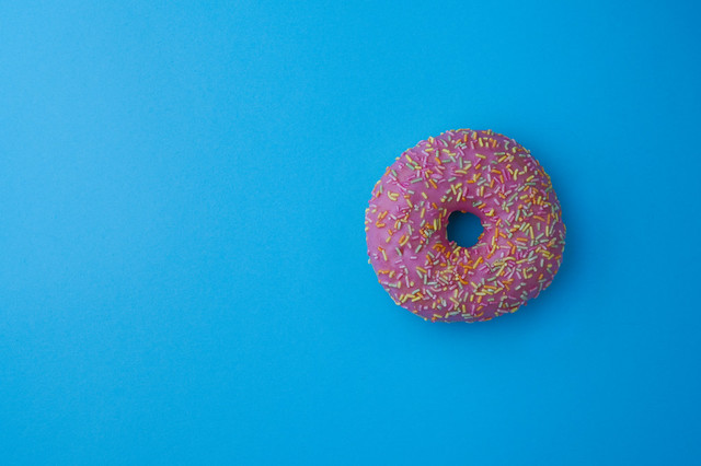 Pink doughnut on a pastel blue background