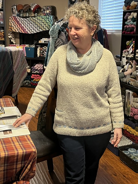 Kathy (chantrykatby) in her Diggory Venn by Isabell Kraemer knit using The Fibre Co Arranmore Light and her Faerie Ring Shawl by Mariam Riddle knit using a single skein of Bergere de France Bigarelle.