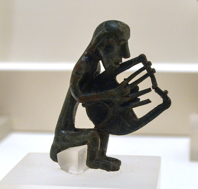 Cretan Geometric bronze figurine of a seated lyre player