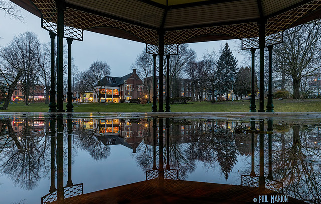 Beaches Library reflecting in puddle inside Christie Bandshell - Kew Gardens