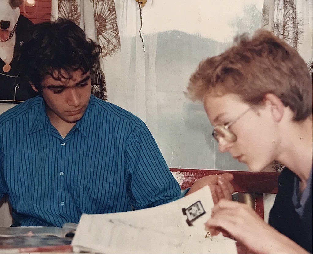 Retrospective 1990s Two nerds reading White Dwarf ( Games workshops tabletop wargaming magazine) one pale with thick glasses and one browner with a unibrow (me) ( yes I had that until my mid teens ) at Brønbys haveby Denmark ( the cottage village )
