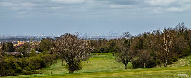 A hazy London from BT Tower to the City of London. Taken from Epsom Downs, North Downs, with Epsom College mid-left, Surrey, England.