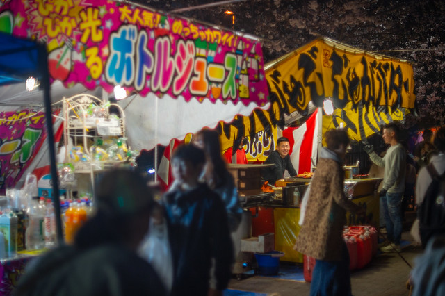 food carts under sakura at night