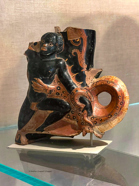 Terracotta rhyton (drinking or libation horn) in the form of a crocodile attacking a black youth