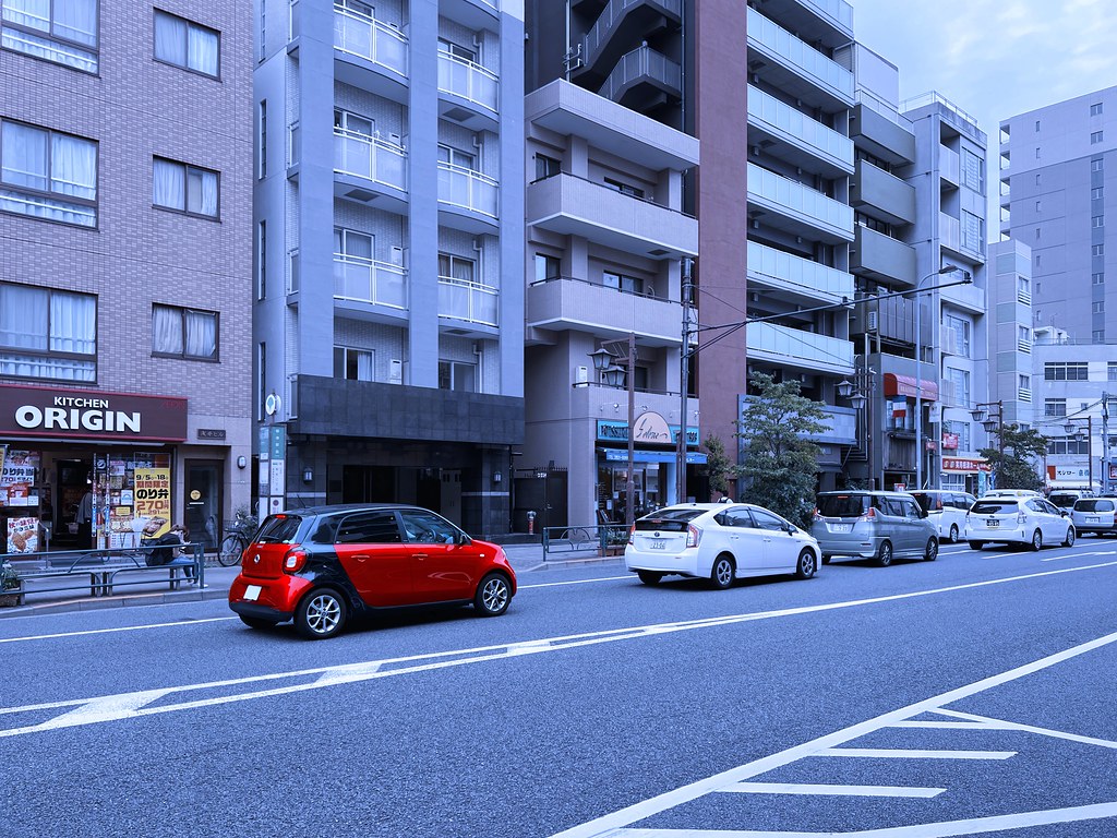 Tokyo City Life with a Red Compact Car