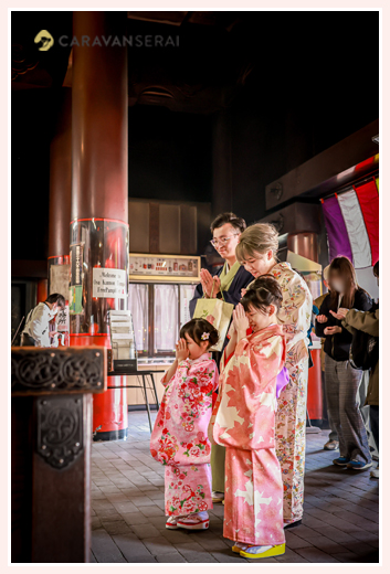 A family praying at Osu Kannon in Nagoya