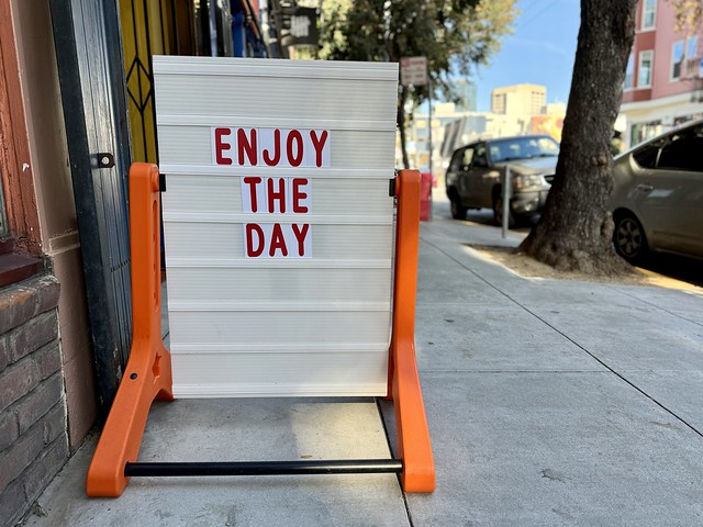 Enjoy the Day sidewalk sign