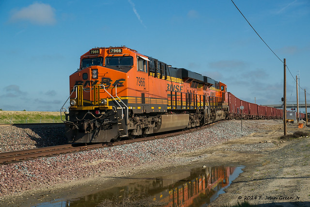 Spring flooding brings out BNSF ballast trains - ES44C4 #7966 & #6950 drop into the siding near Wasco in Talere County California