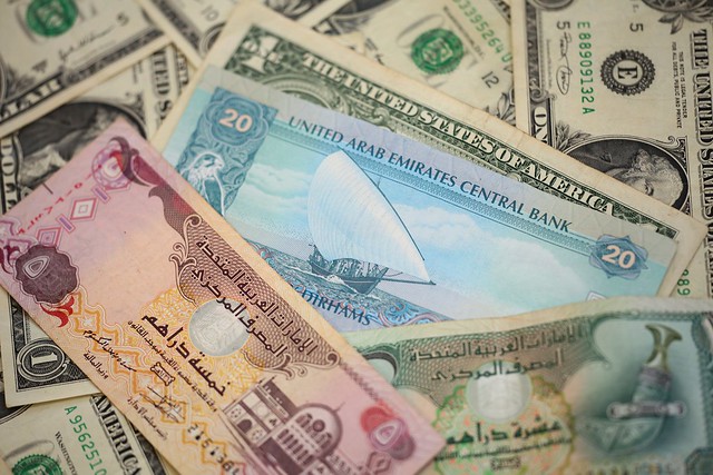Heap Of US Dollars And UAE Dirhams Money