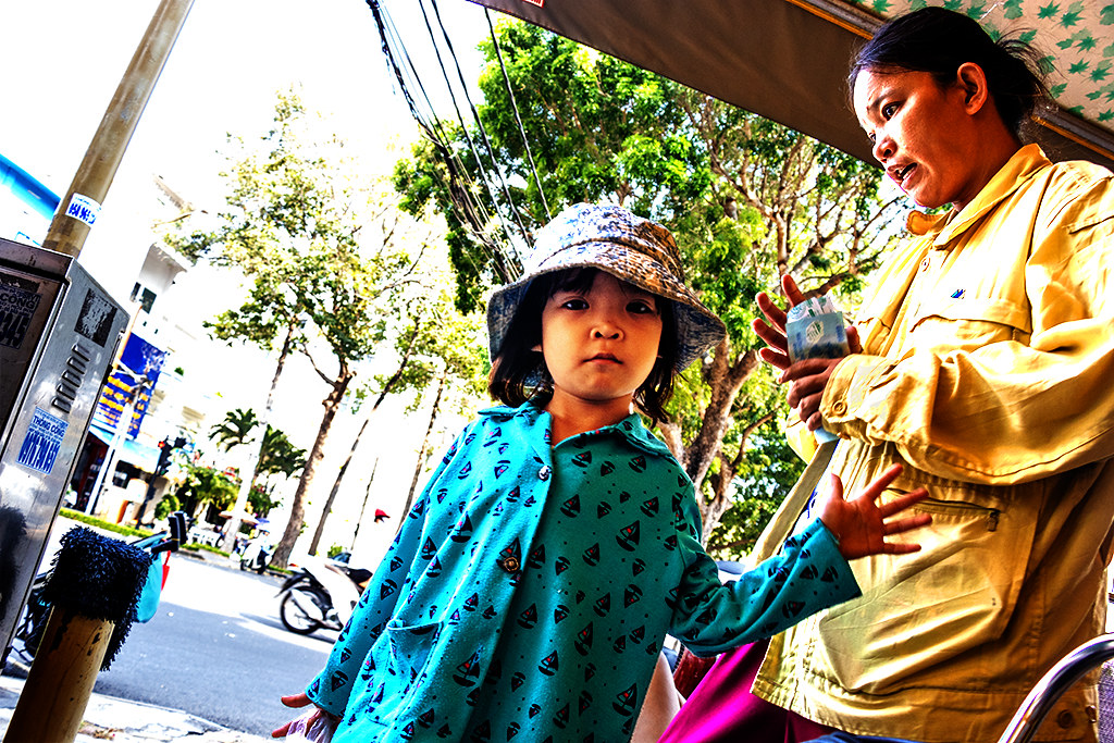 Little girl with her lottery ticket selling mom at Coc Coc Coffee on 4-14-24--Vung Tau copy