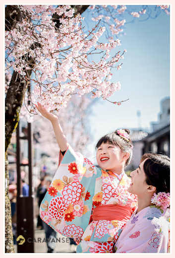 girl admiring cherry blossoms in full bloom