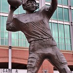 Baltimore: M&T Bank Stadium - Johnny Unitas The Baltimore Ravens erected a statue of Johnny Unitas sculpted by local artist Frederick Nail, outside gate A at M&amp;amp;T Bank Stadium in October 2002.  The Hall of Fame quarterback starred for the team&#039;s predecessors, the Baltimore Colts, from 1956 to 1972.  He won three MVP awards and led the Colts to four championship titles spanning the pre-merger and Super Bowl eras.  Just a month after the local icon&#039;s passing at the age of 69, the Colts dedicated the area in front of the stadium&#039;s main entrance as Unitas Plaza with the dedication of the statue as its centerpiece.