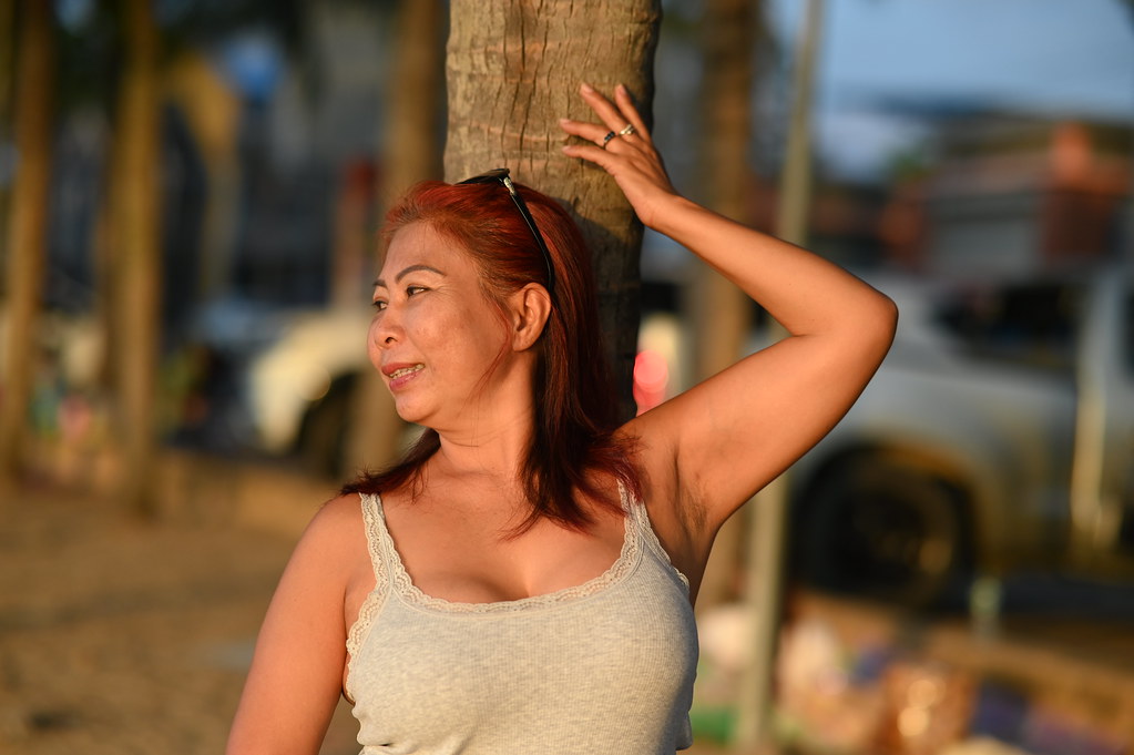 DSC_1721: a woman standing next to a palm tree
