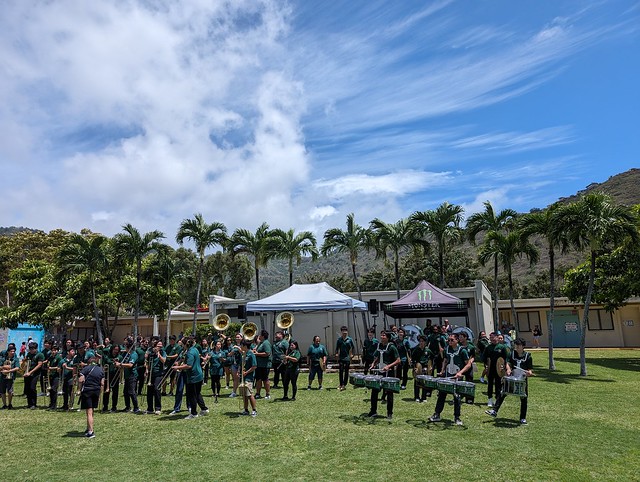 Outdoor Marching Band Performance Under Sunny Skies at a Community Event