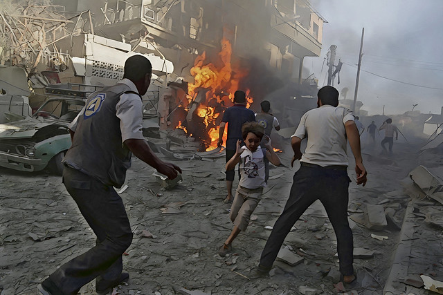 A boy runs as he rushes away from a site hit by what activists said were airstrikes by forces loyal to Syria's President Bashar al-Assad in the Douma neighborhood of Damascus, Syria, on August 24, 2015 (Bassam Khabieh - Reuters)